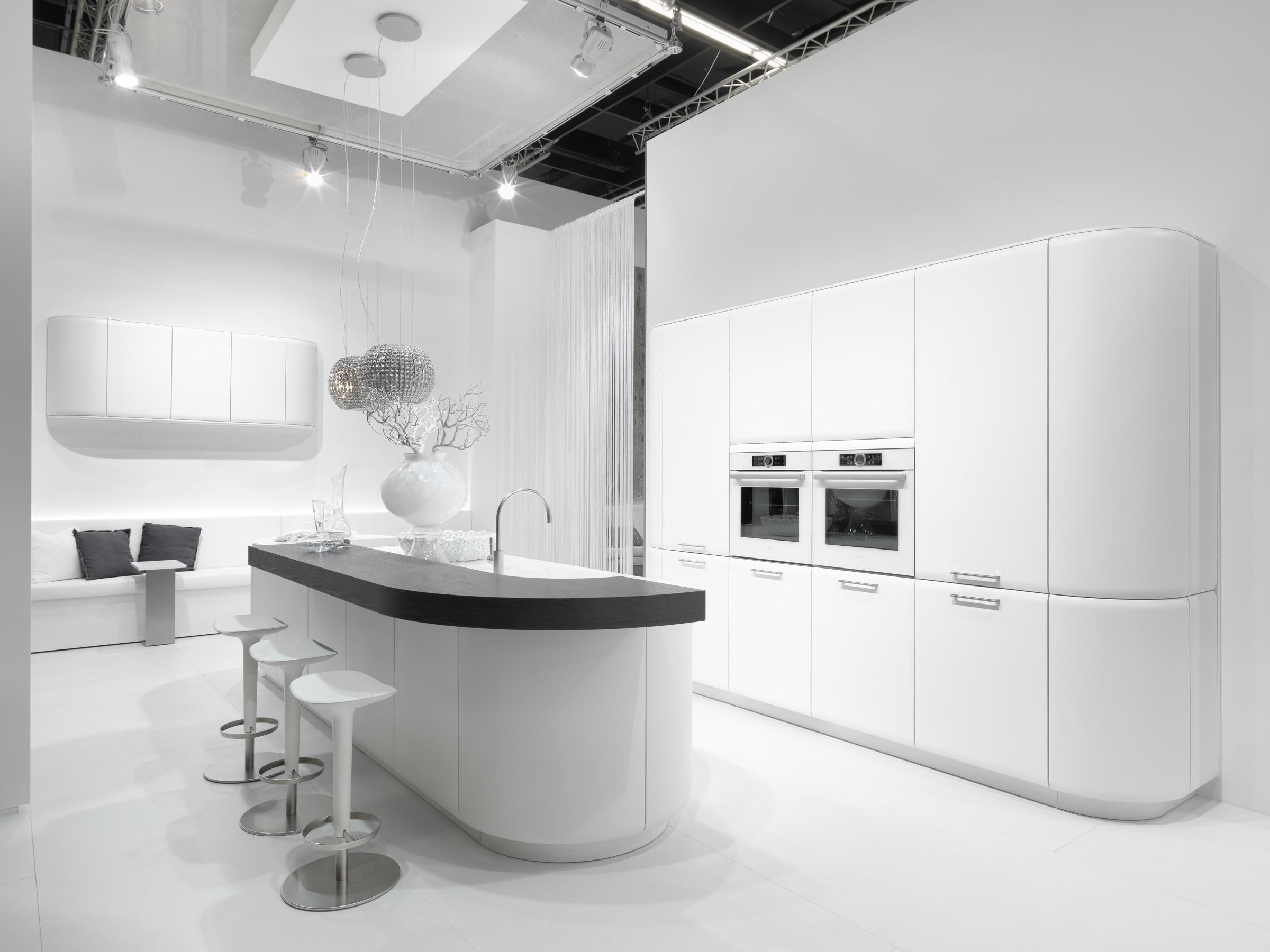 Rational 'Onda' kitchen in gloss white with a curved island and dark oak worktop